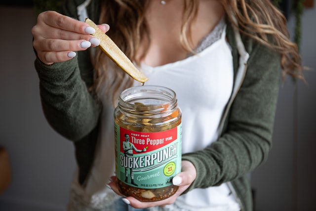 woman holding pickle jar